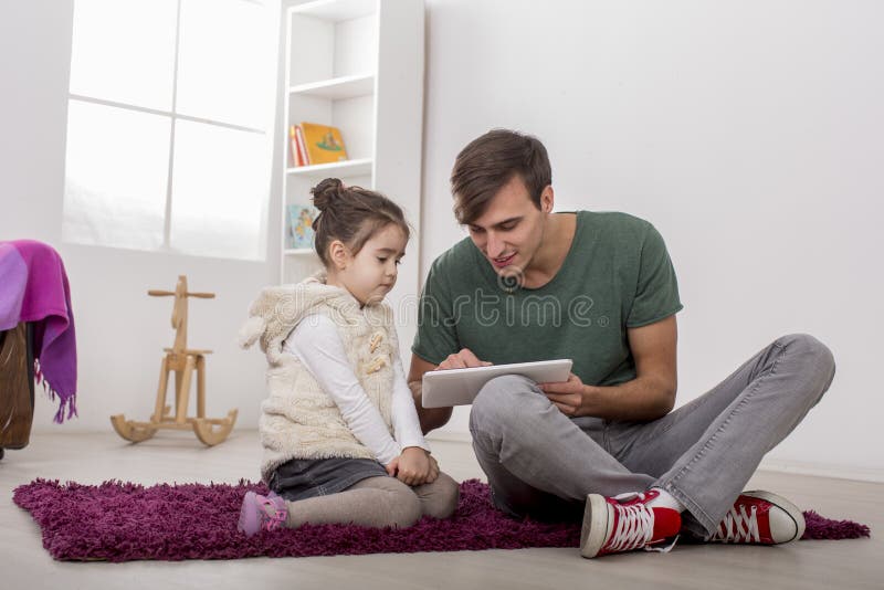 Father and daughter with a tablet royalty free stock images