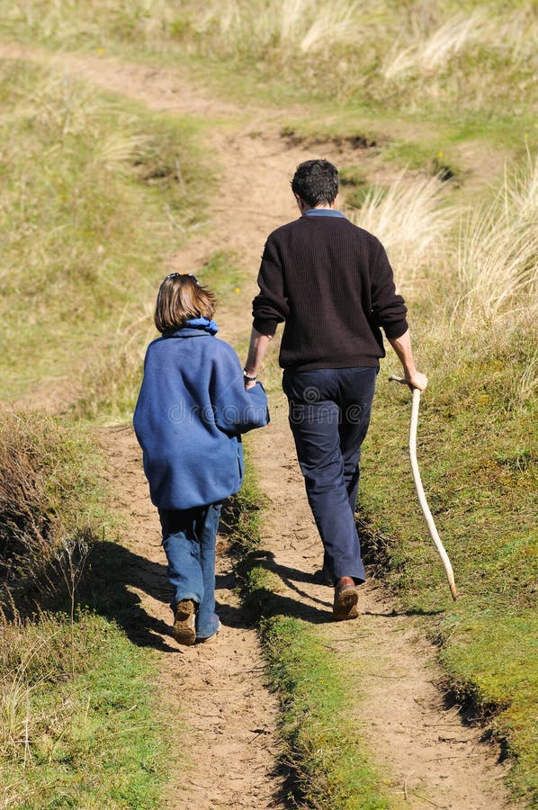 Father and daughter walking in countryside