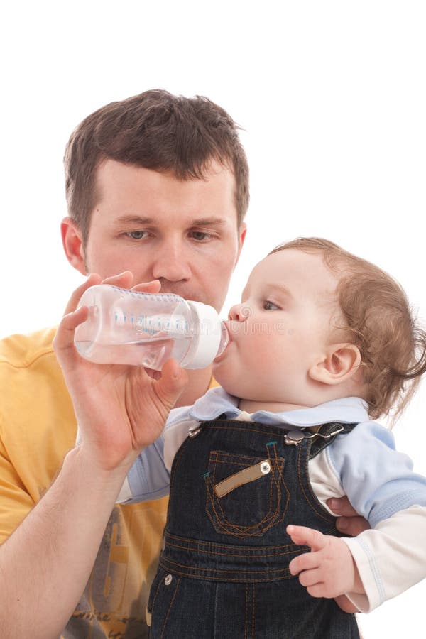 Father give drink her son by feeding bottle. Over white