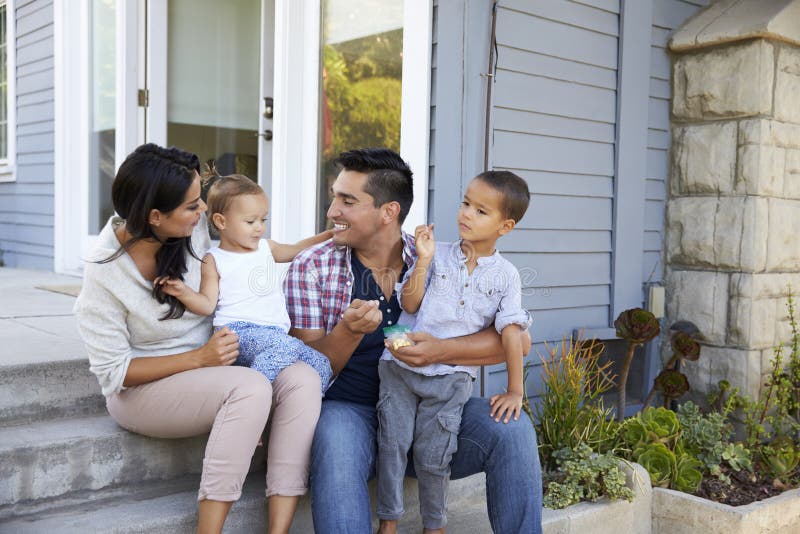 Father Giving Children Candy On Steps Outside Hose royalty free stock image Father Giving Children Candy On Steps Outside Hose royalty free stock image