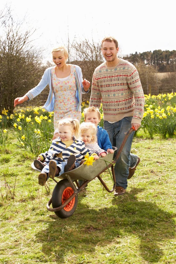 Father Giving Children Ride In Wheelbarrow