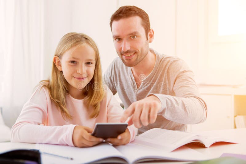 Father helping out her daughter for homework.