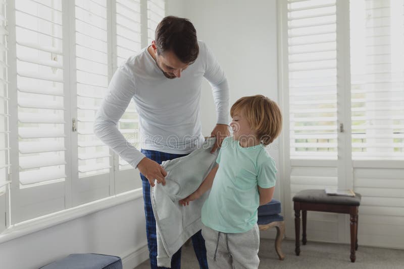Father Helping Son Putting on Clothes Stock Photo Image of father