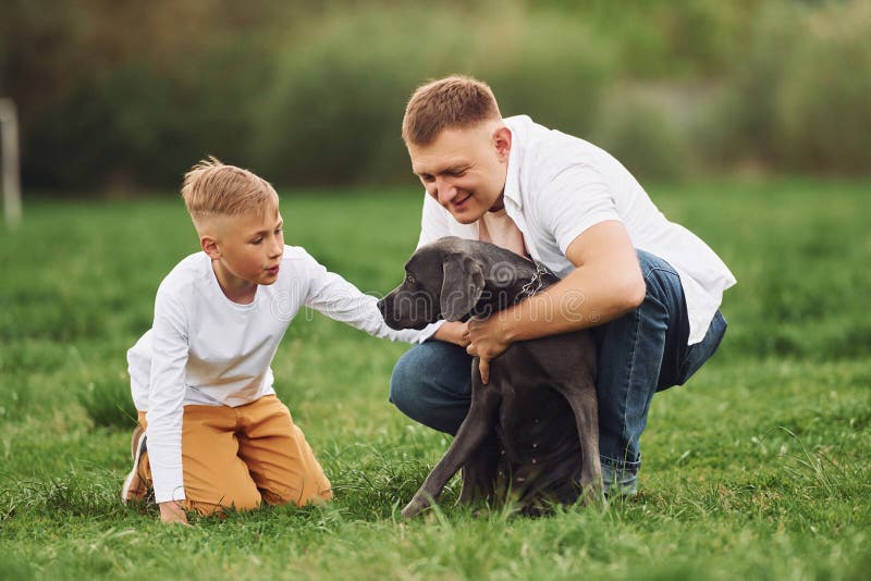 Father with His Young Son Have a Walk. with Dog Stock Image - Image of ...