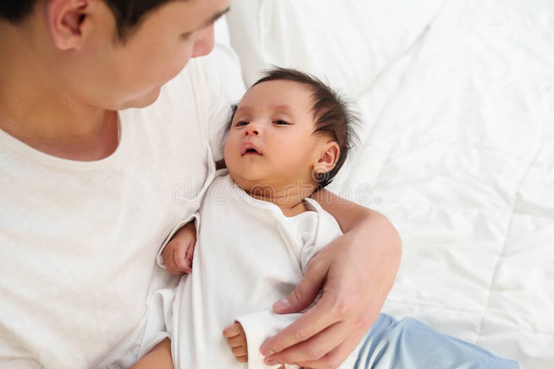 Father Holding Newborn Baby on Bed Stock Image Image of lifestyle
