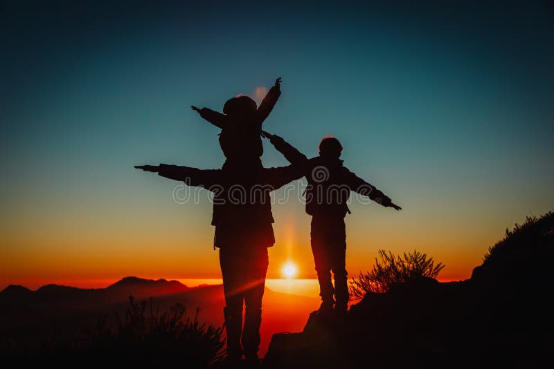 Father with kids travel in sunset mountains, family hiking in nature