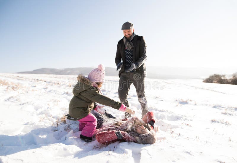 Father, mother and their daughter having fun in winter nature. stock images Father, mother and their daughter having fun in winter nature. stock images