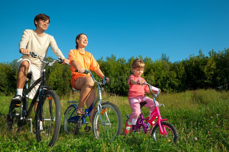 Father, mum and daughter go for drive on bicycles