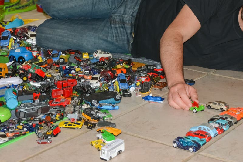 Father plays with son`s toy cars on the floor royalty free stock photography Father plays with son`s toy cars on the floor royalty free stock photography