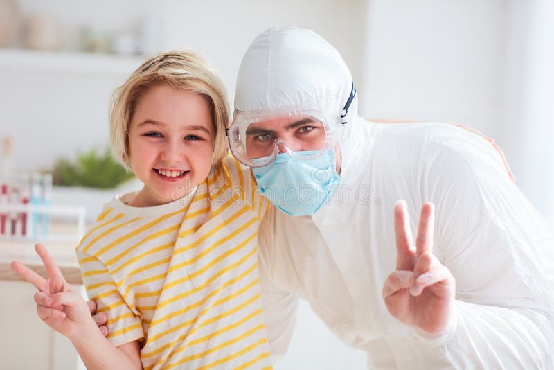Father in protective medical suit having fun, hugging with infected, contagious boy, visiting hospitalized son royalty free stock photography Father in protective medical suit having fun, hugging with infected, contagious boy, visiting hospitalized son royalty free stock photography