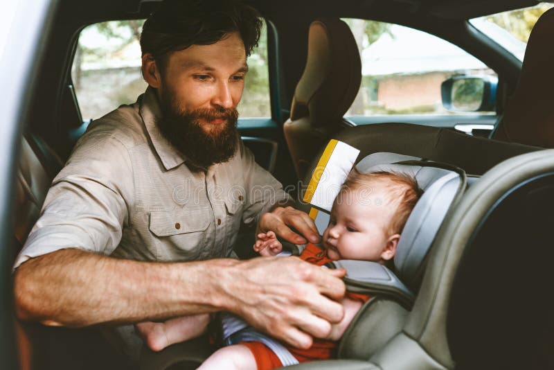 Father putting baby in safety car seat happy family royalty free stock image Father putting baby in safety car seat happy family royalty free stock image