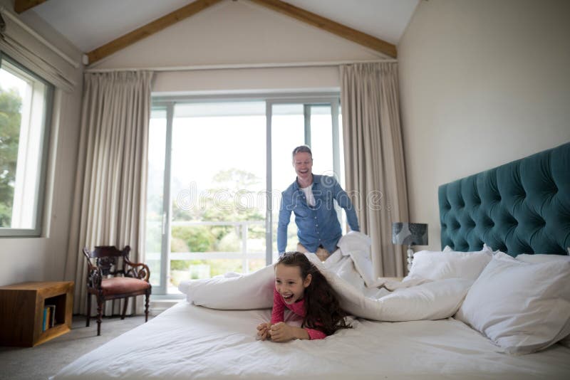 Father Putting a White Blanket Over His Daughter Stock Image Image of