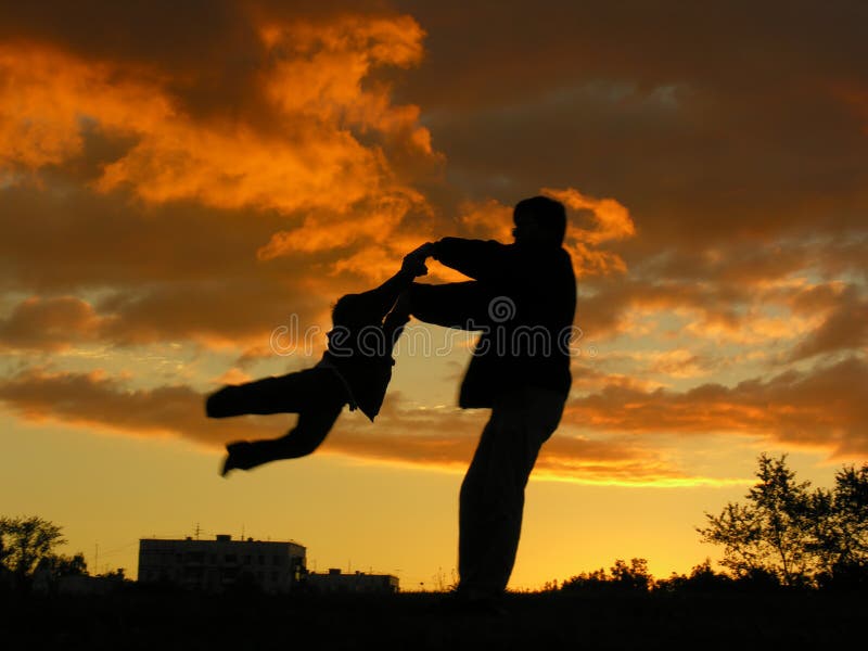 Father rotate son sunset stock photos