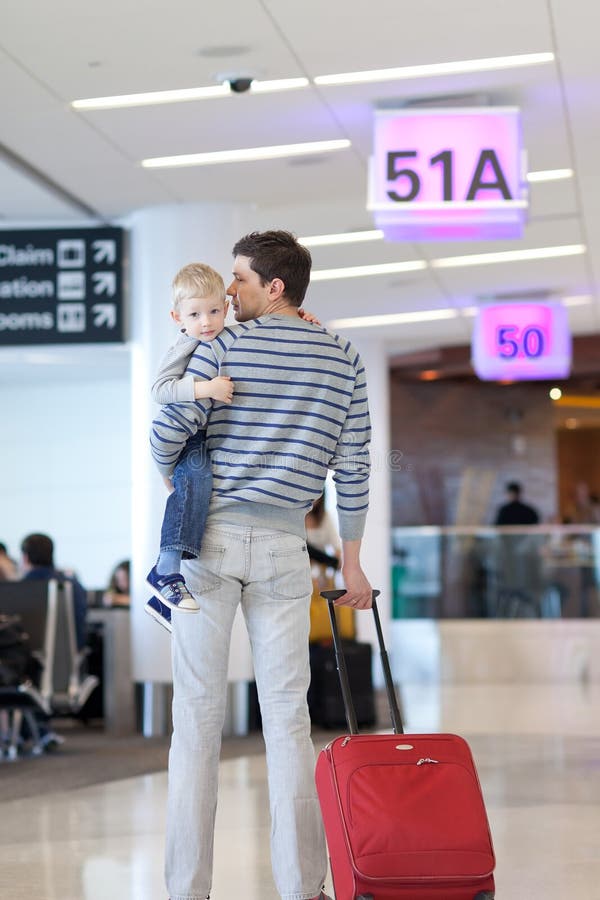 Father and son at the airport. Father and son waiting together at the airport Father and son at the airport. Father and son waiting together at the airport