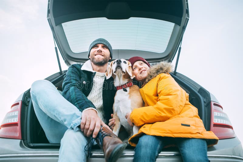 Father and son with beagle dog siting together in car trunk. Lon royalty free stock photography Father and son with beagle dog siting together in car trunk. Lon royalty free stock photography