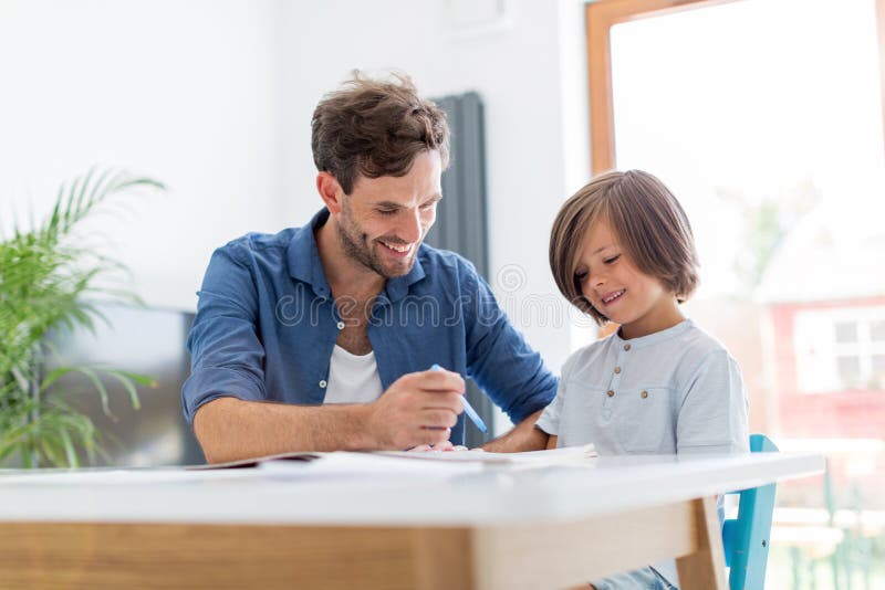Father and son doing homework together stock photos