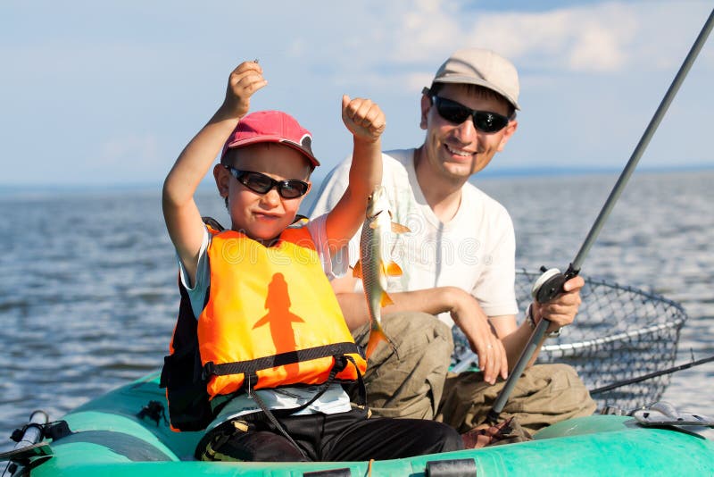 Father and son fish in a boat