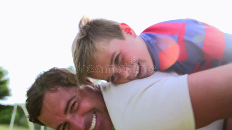 Father And Son Having Fun In Garden