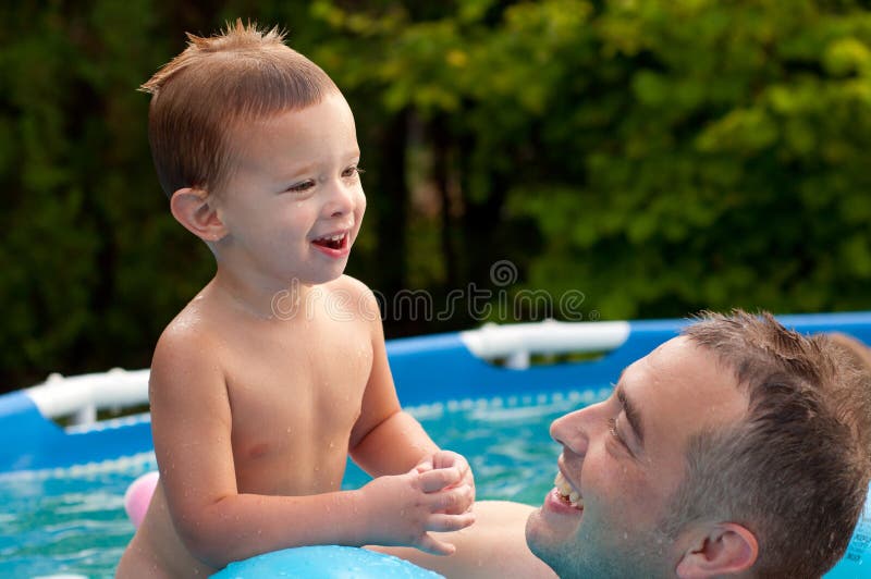 Playful Father And Son Having Fun In Swimming Pool Stock Image Image