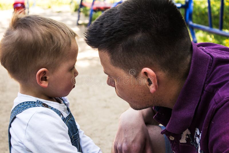 Father and son having talk outside stock images Father and son having talk outside stock images