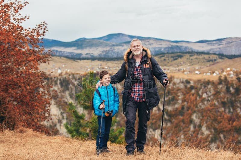 Father with son hiking in nature royalty free stock image
