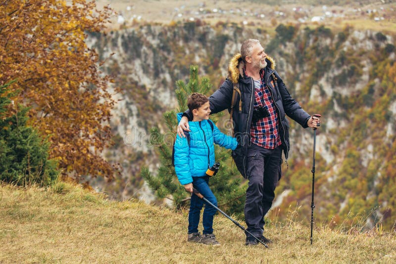 Father with son hiking in nature stock photo