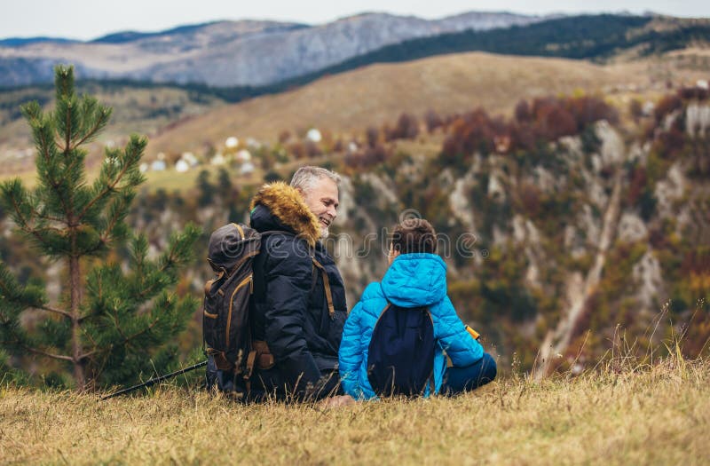 Father with son hiking in nature stock images