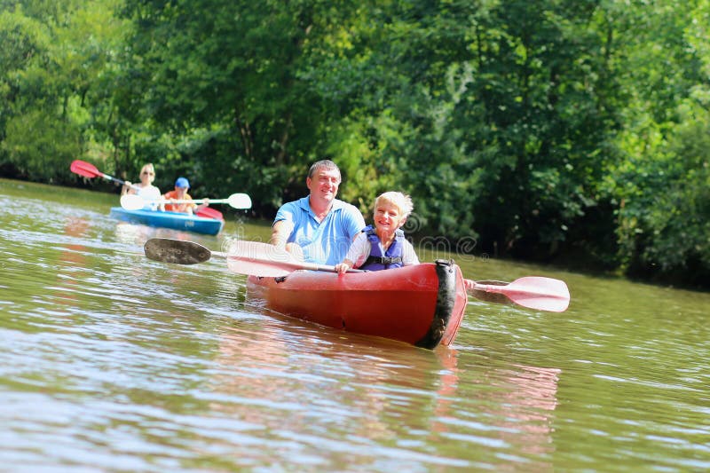 Father and son kayaking on the river