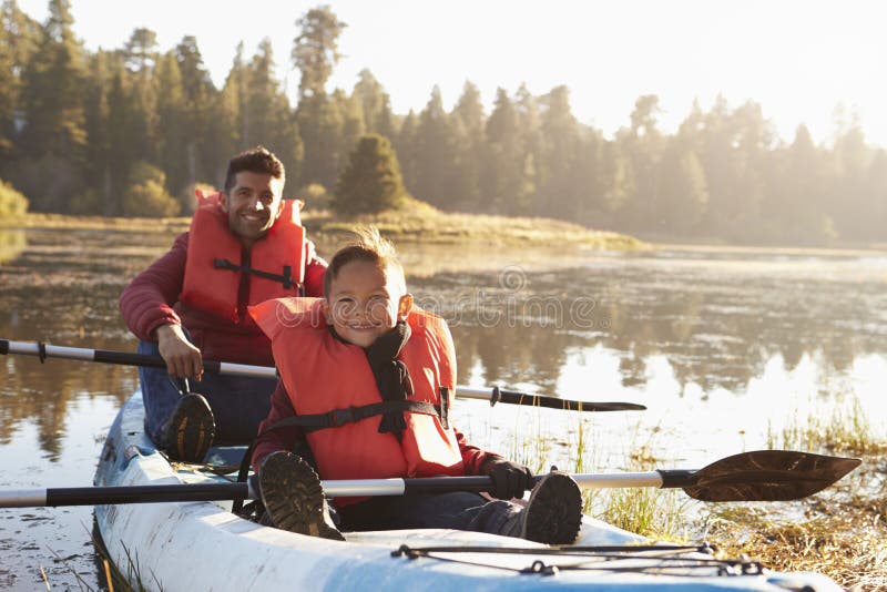 Father and son kayaking on rural lake, close up stock images Father and son kayaking on rural lake, close up stock images