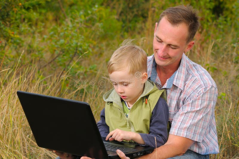 Father and son with laptop