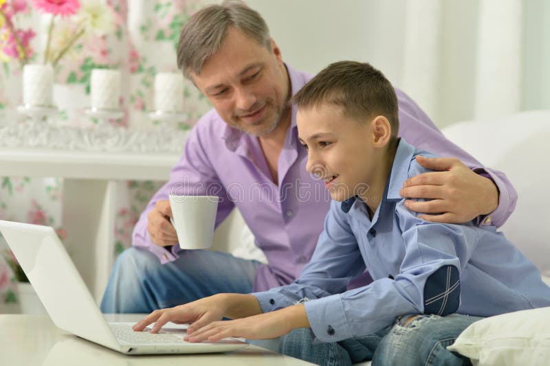 Father and son with laptop