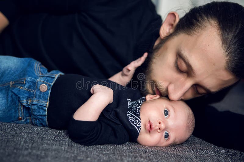 Newborn Baby Lying In Blue Jeans And A Black Scarf by Elena Saulich