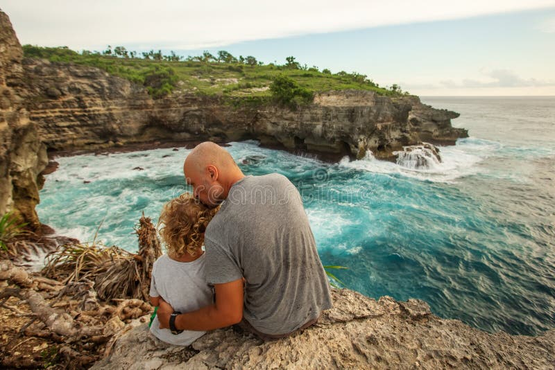 Father with son by the ocean royalty free stock image