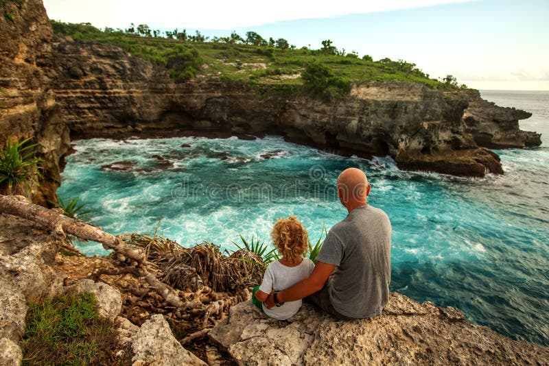 Father with son by the ocean royalty free stock images