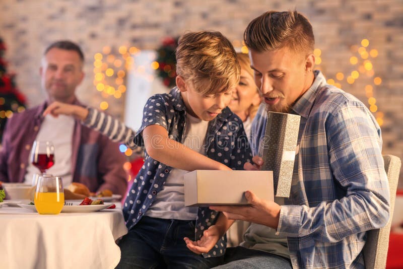 Father and son opening Christmas gift at home royalty free stock images Father and son opening Christmas gift at home royalty free stock images