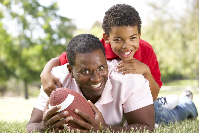 Father and Son in Park with American Football Stock Photo - Image of