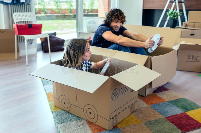 Father and son playing car racing with cardboard boxes stock image Father and son playing car racing with cardboard boxes stock image