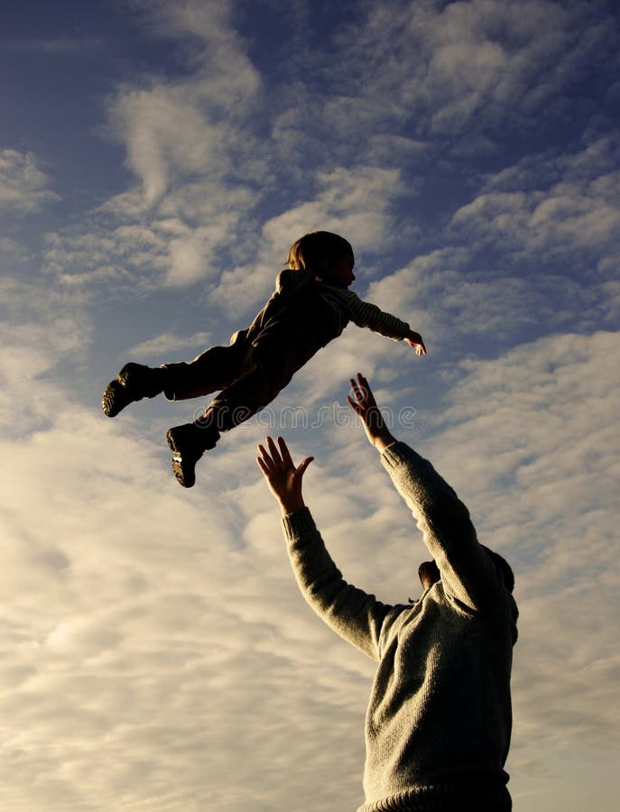 Father and son playing on sky background