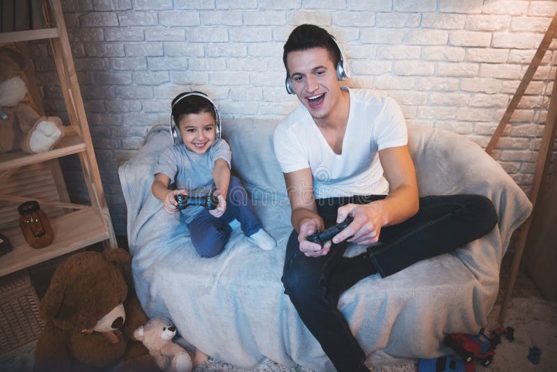 Young People Playing Video Games At Home Stock Photo, Picture and Royalty  Free Image. Image 113583143.