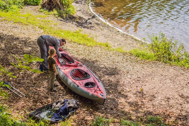 Father and Son Prepare a Kayak for Rowing on the Sea Stock Photo Image of lifestyle, adventure