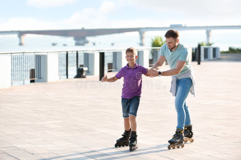 Father and Son Roller Skating on Street Stock Photo Image of outdoors