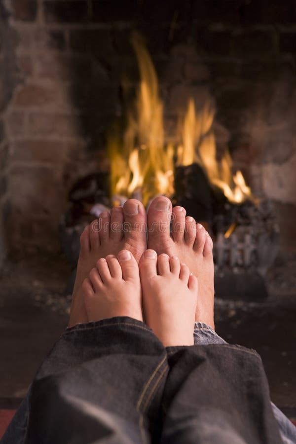 Father and Son S Feet Warming at a Fireplace Stock Photo Image of