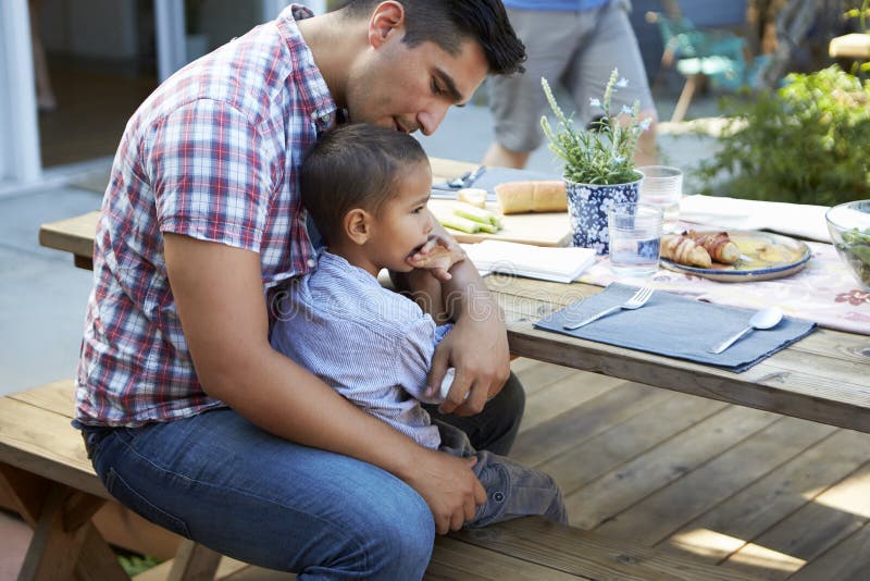 father-son-sitting-table-outdoor-meal-garden-85184114.jpg