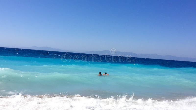 Father and son swim in the Aegean Sea stock images Father and son swim in the Aegean Sea stock images