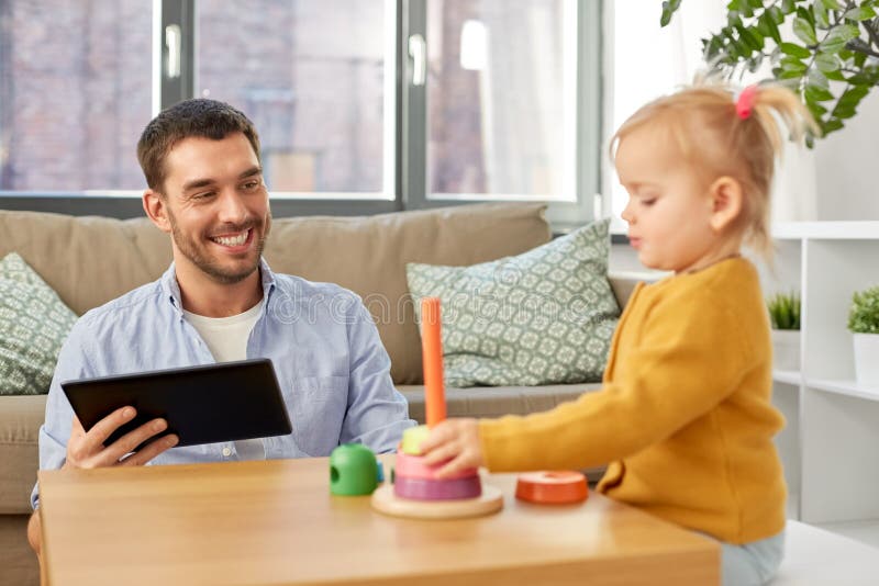 Father with tablet pc and baby daughter at home royalty free stock images Father with tablet pc and baby daughter at home royalty free stock images