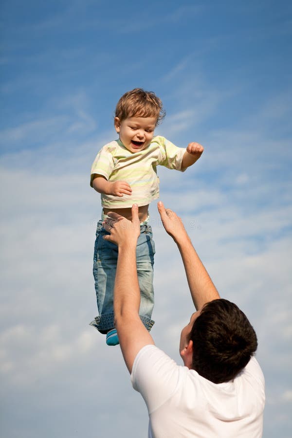 Father throwing baby boy stock photo. Image of parenthood 28810480