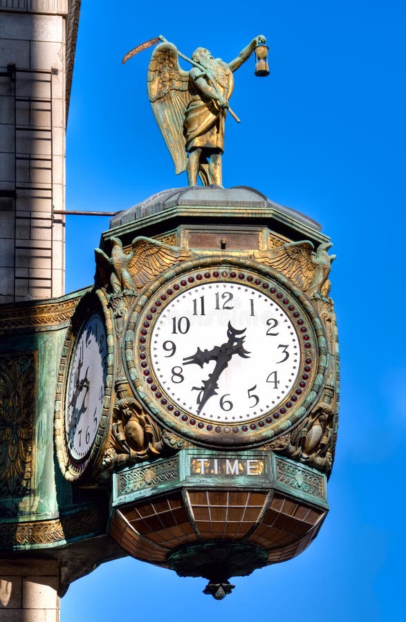 The 1926 decorative jewelers' Building clock at the corner of Wabash and Wacker in Chicago is emblazoned with the word TIME and decorated with a statue of old Father Time himself holding his scythe and sand timer. The 1926 decorative jewelers' Building clock at the corner of Wabash and Wacker in Chicago is emblazoned with the word TIME and decorated with a statue of old Father Time himself holding his scythe and sand timer.