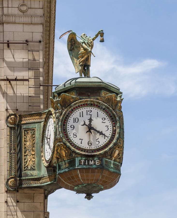 This ornate, eight ton, huge clock on the corner of the Jewelers Building (35 East Wacker) in Chicago was a gift to the Chicago Jeweler's Association by the Elgin Watch Company of Illinois. The specific artist is unknown. The date of creation of the clock and sculpture is also unknown but it was installed on the corner of the building in 1926. The sculpture on top of the clock is of Father Time. This statue is five feet tall and shows a wizened old bearded man holding an hourglass, with a scythe over his shoulder, a very traditional and ancient representation of this character. This ornate, eight ton, huge clock on the corner of the Jewelers Building (35 East Wacker) in Chicago was a gift to the Chicago Jeweler's Association by the Elgin Watch Company of Illinois. The specific artist is unknown. The date of creation of the clock and sculpture is also unknown but it was installed on the corner of the building in 1926. The sculpture on top of the clock is of Father Time. This statue is five feet tall and shows a wizened old bearded man holding an hourglass, with a scythe over his shoulder, a very traditional and ancient representation of this character.