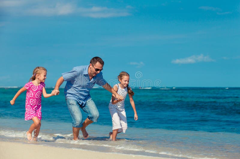 Dad and Two Daughters Running Along the Beach Stock Photo Image of(02)
