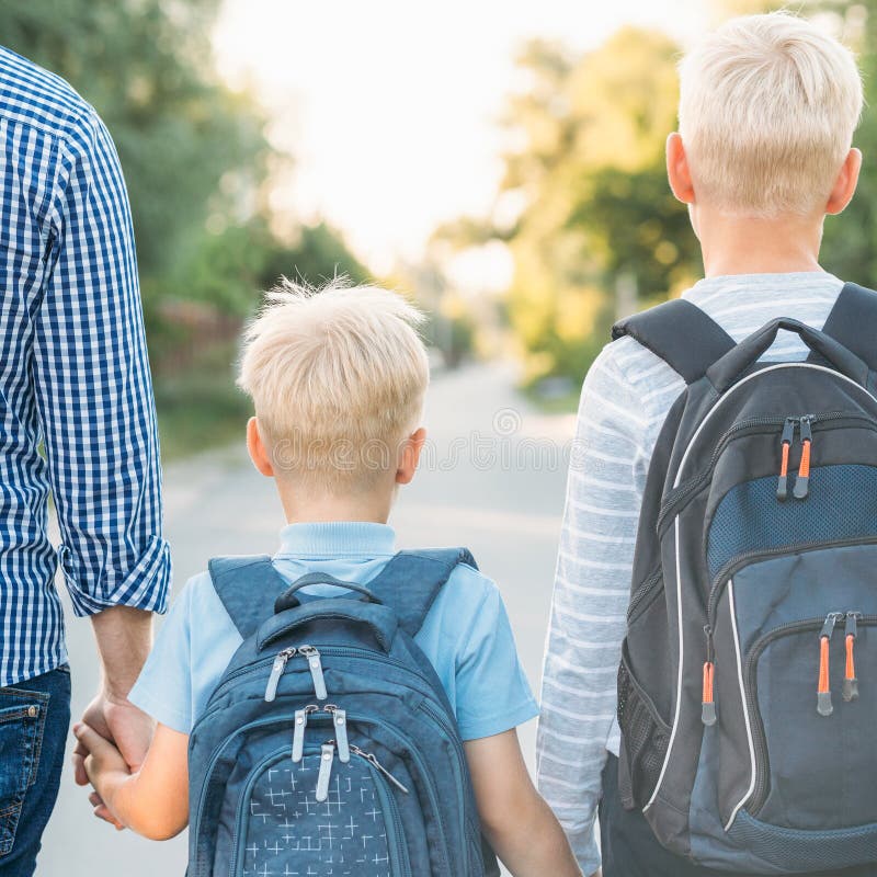 Father and two sons going to school.